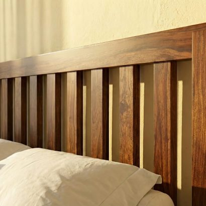 Solid Sheesham Wood Slatted King Size Bed with vertical panel headboard and footboard in a modern bedroom featuring natural wood finish and white bedding.