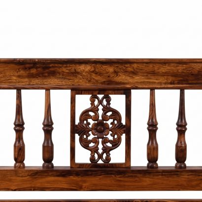 Premium carved wooden bed online made from solid Sheesham wood with an elegant carved headboard and classic spindle design.