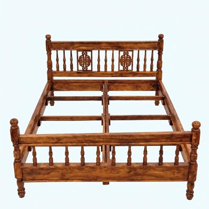 Premium carved wooden bed online made from solid Sheesham wood with an elegant carved headboard and classic spindle design.