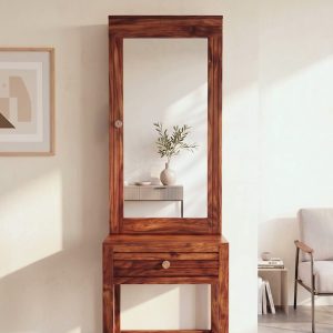 Solid Sheesham wood dressing table with large rectangular mirror and storage drawer, placed in a modern minimalist bedroom with natural lighting.